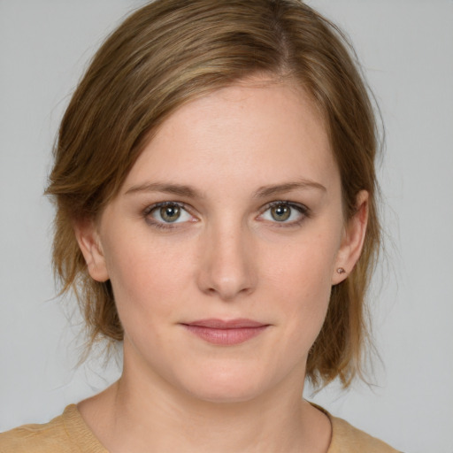 Joyful white young-adult female with medium  brown hair and blue eyes