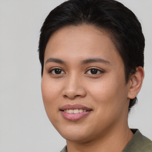 Joyful asian young-adult female with short  brown hair and brown eyes