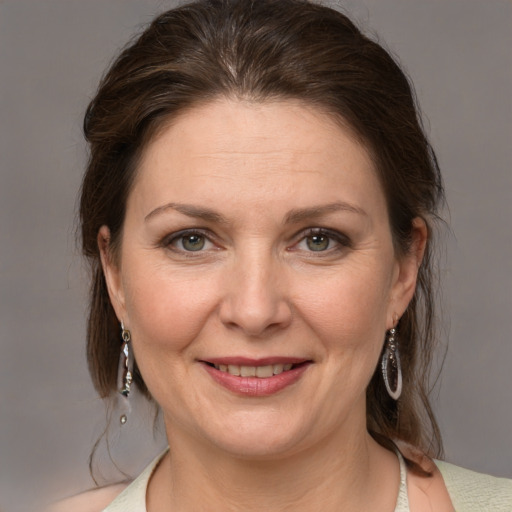 Joyful white adult female with medium  brown hair and grey eyes