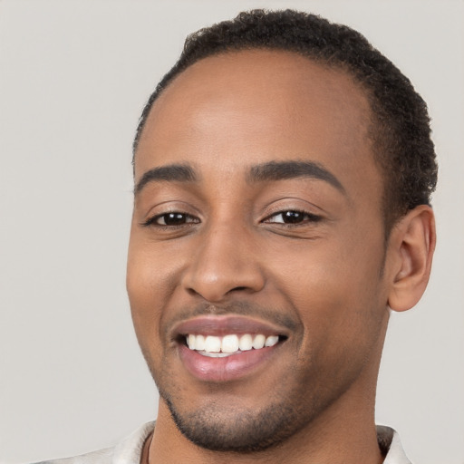 Joyful black young-adult male with short  brown hair and brown eyes