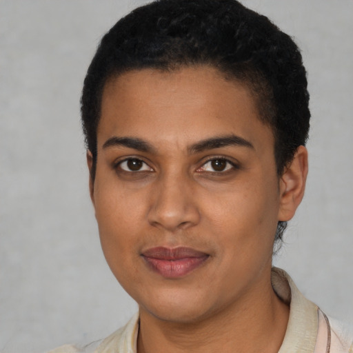 Joyful latino young-adult female with short  black hair and brown eyes