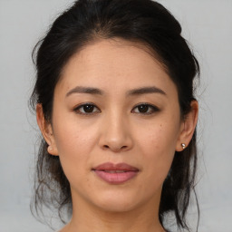 Joyful asian young-adult female with medium  brown hair and brown eyes