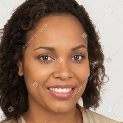 Joyful black young-adult female with long  brown hair and brown eyes