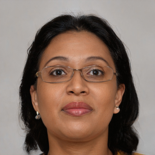 Joyful latino adult female with medium  brown hair and brown eyes