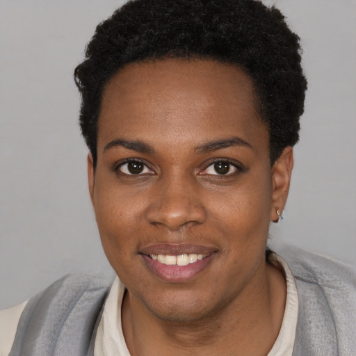 Joyful black young-adult female with short  brown hair and brown eyes