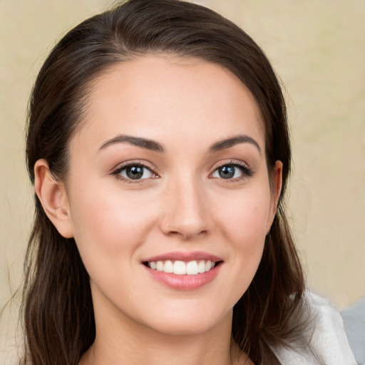 Joyful white young-adult female with medium  brown hair and grey eyes