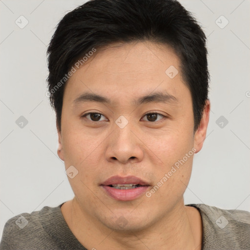 Joyful asian young-adult male with short  brown hair and brown eyes