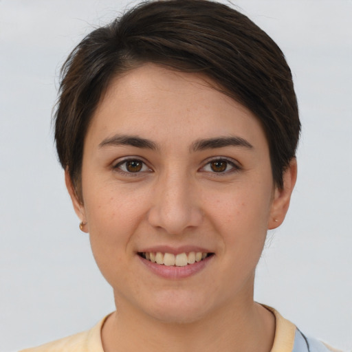 Joyful white young-adult female with short  brown hair and brown eyes