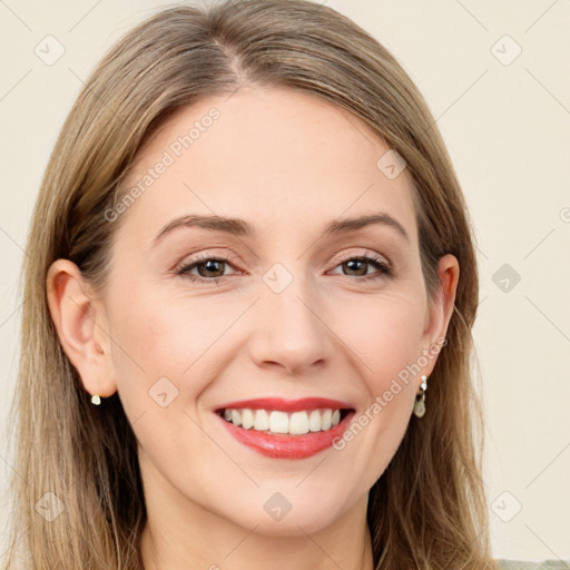 Joyful white young-adult female with long  brown hair and green eyes