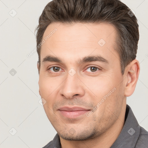 Joyful white young-adult male with short  brown hair and brown eyes