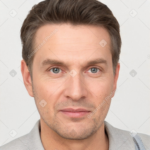 Joyful white adult male with short  brown hair and grey eyes