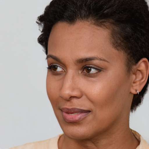 Joyful latino young-adult female with short  brown hair and brown eyes