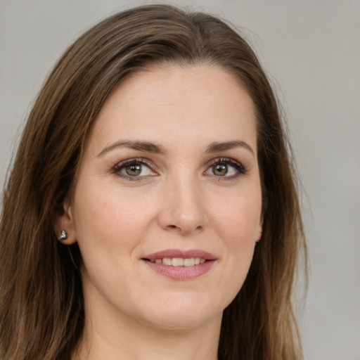 Joyful white young-adult female with long  brown hair and green eyes