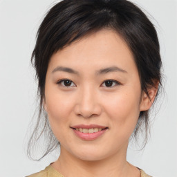 Joyful asian young-adult female with medium  brown hair and brown eyes