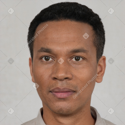 Joyful black young-adult male with short  black hair and brown eyes