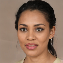 Joyful latino young-adult female with medium  brown hair and brown eyes