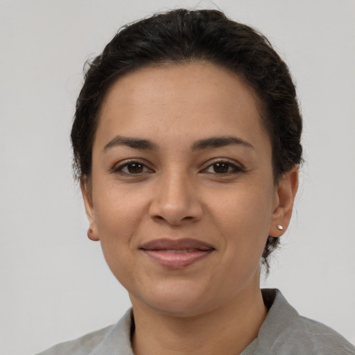 Joyful latino young-adult female with short  brown hair and brown eyes