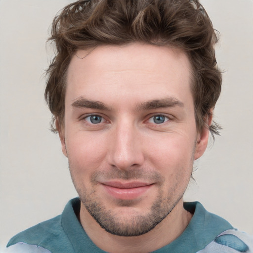 Joyful white young-adult male with short  brown hair and blue eyes