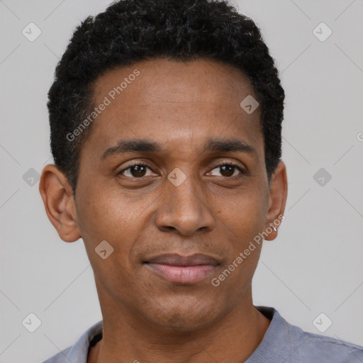 Joyful black young-adult male with short  black hair and brown eyes