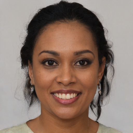 Joyful black young-adult female with medium  brown hair and brown eyes