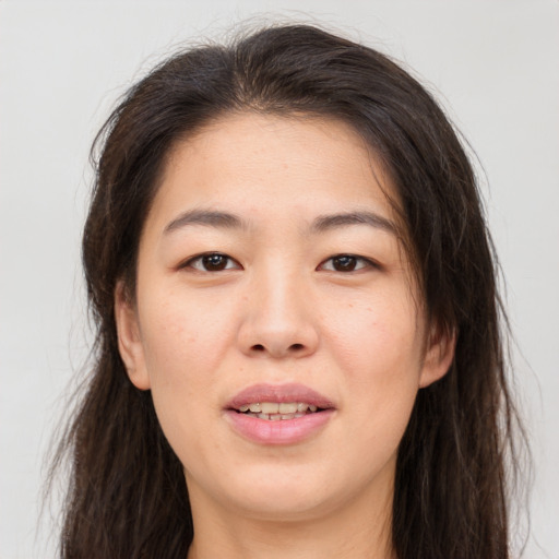 Joyful asian young-adult female with long  brown hair and brown eyes