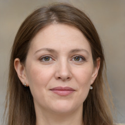 Joyful white adult female with long  brown hair and grey eyes