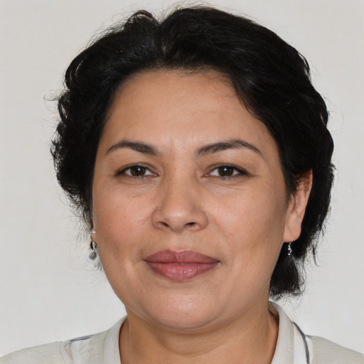 Joyful latino adult female with medium  brown hair and brown eyes