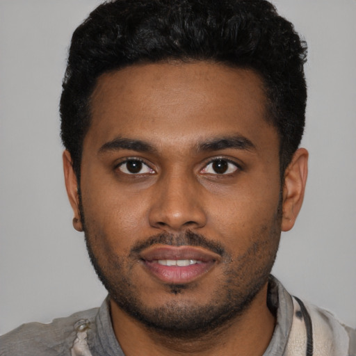 Joyful latino young-adult male with short  black hair and brown eyes