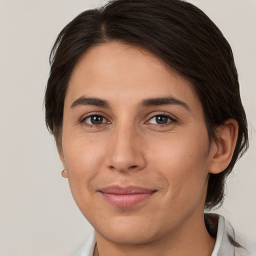 Joyful white young-adult female with medium  brown hair and brown eyes