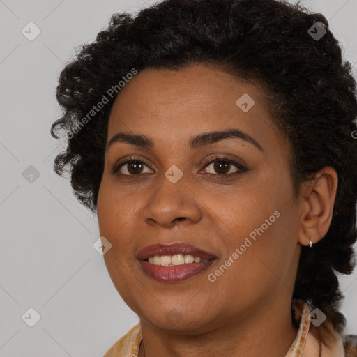 Joyful black young-adult female with long  brown hair and brown eyes