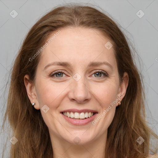 Joyful white adult female with long  brown hair and grey eyes