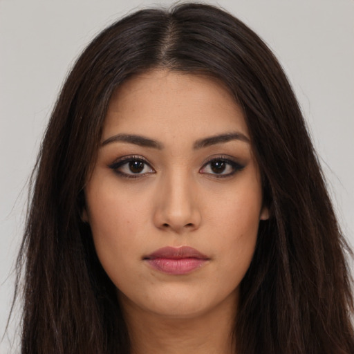 Neutral latino young-adult female with long  brown hair and brown eyes
