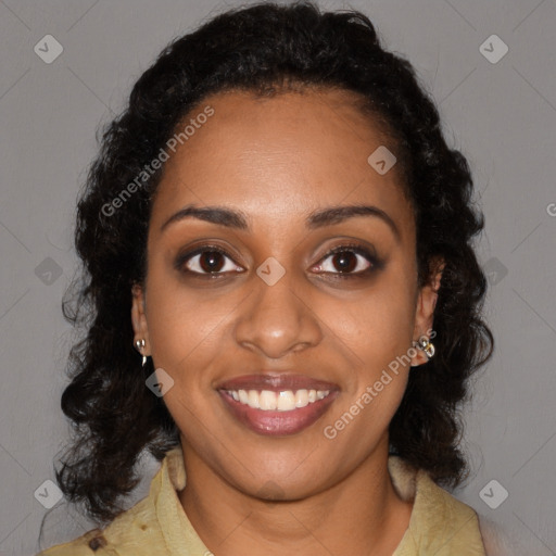 Joyful black young-adult female with long  black hair and brown eyes