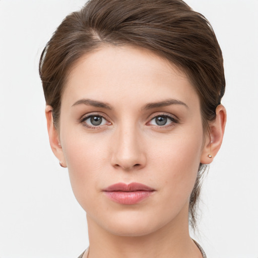 Joyful white young-adult female with short  brown hair and grey eyes