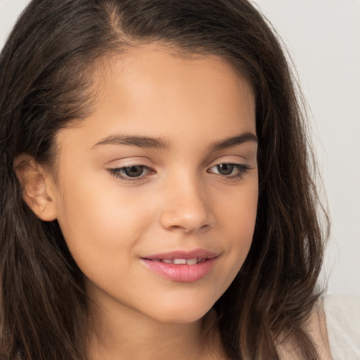 Joyful white child female with long  brown hair and brown eyes