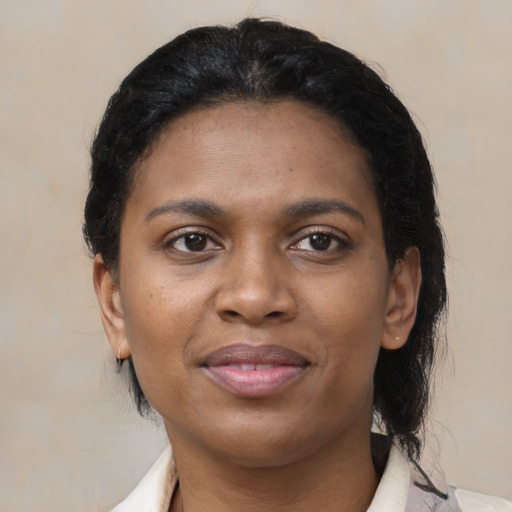 Joyful black young-adult female with medium  brown hair and brown eyes