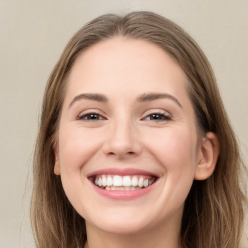 Joyful white young-adult female with long  brown hair and green eyes