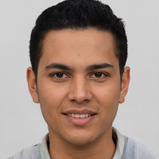 Joyful latino young-adult male with short  brown hair and brown eyes