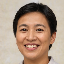 Joyful asian adult female with short  brown hair and brown eyes