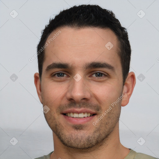 Joyful white young-adult male with short  black hair and brown eyes