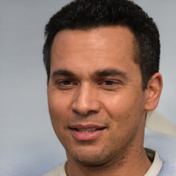 Joyful white young-adult male with short  black hair and brown eyes