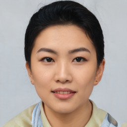 Joyful asian young-adult female with short  black hair and brown eyes