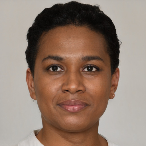Joyful black young-adult female with short  black hair and brown eyes