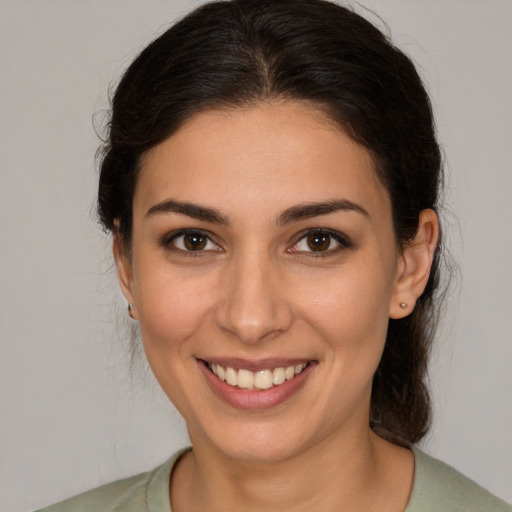 Joyful white young-adult female with medium  brown hair and brown eyes