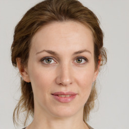 Joyful white young-adult female with medium  brown hair and green eyes