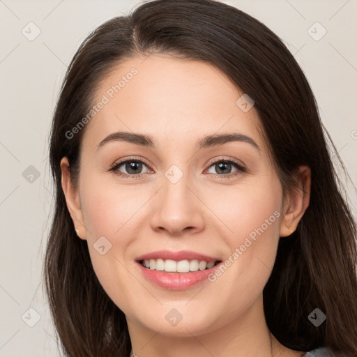 Joyful white young-adult female with long  brown hair and brown eyes