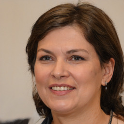 Joyful white adult female with medium  brown hair and brown eyes