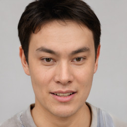 Joyful asian young-adult male with short  brown hair and brown eyes