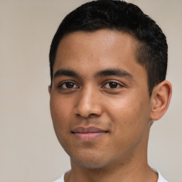 Joyful latino young-adult male with short  black hair and brown eyes