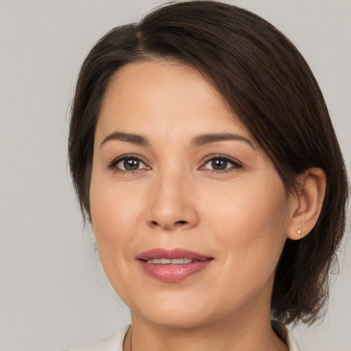 Joyful white young-adult female with medium  brown hair and brown eyes